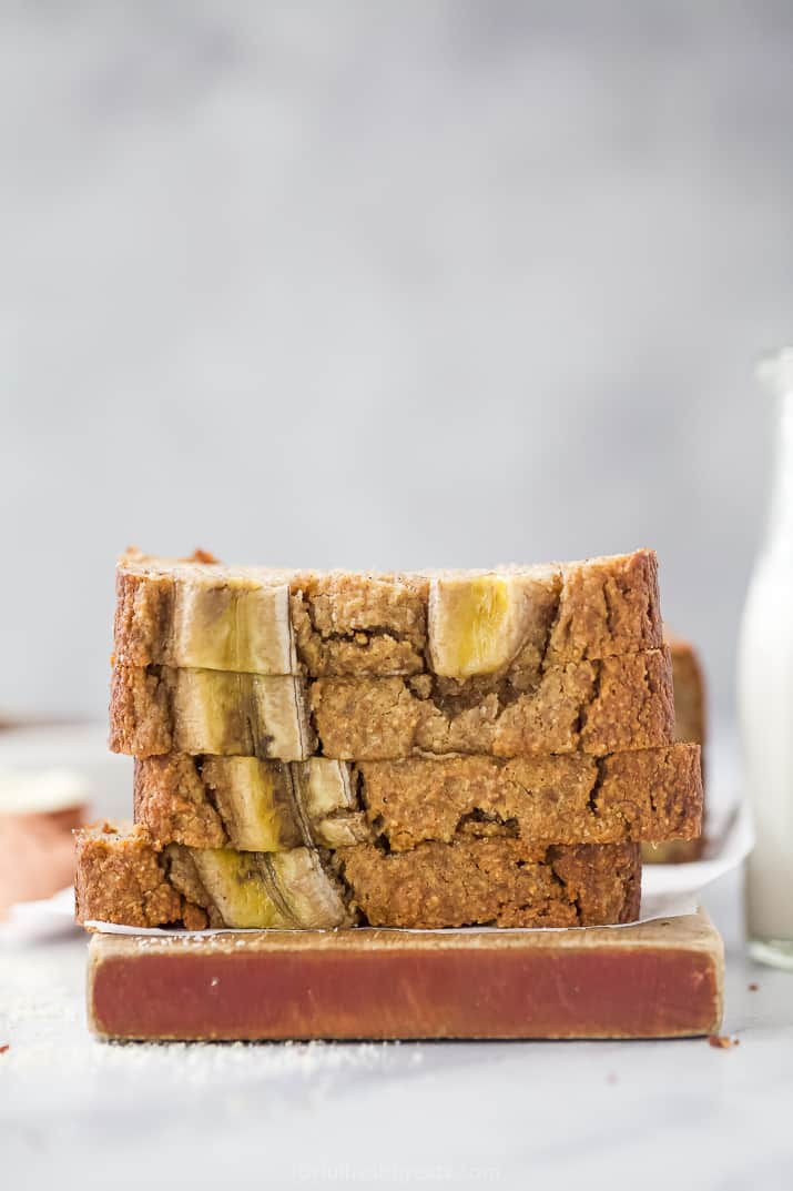 The Best Almond Flour Banana Bread Ever 四片切片堆积在切板的paleo香蕉面包