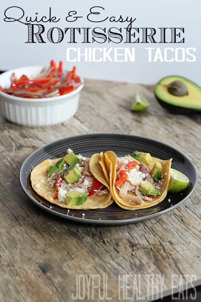 Rotisserie Chicken Tacos #chickentacos #easymeals #rotisseriechicken Shredded Chicken Tacos on a black plate and surrounded by fresh ingredients