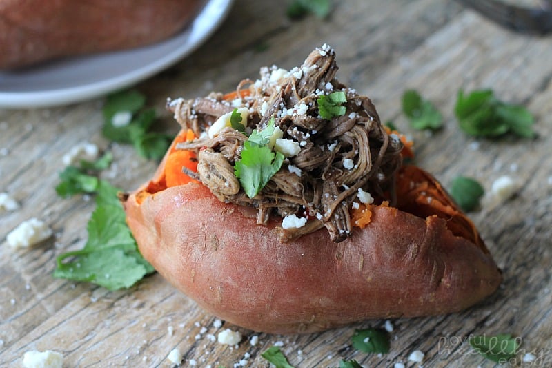 Chipotle牛肉Barbacoa充塞在一个木板的甜土豆