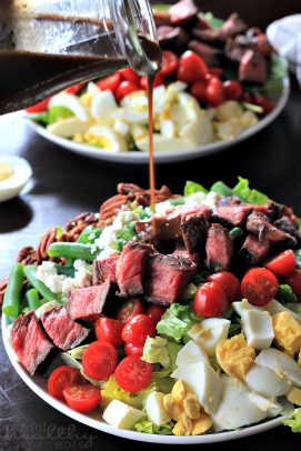 The Most Popular Recipes of Joyful Healthy Eats 2014 | m.albarakaa.com | #mostpinned #healthy #recipes #food Steak Cobb salad being drizzled with balsamic vinegarette