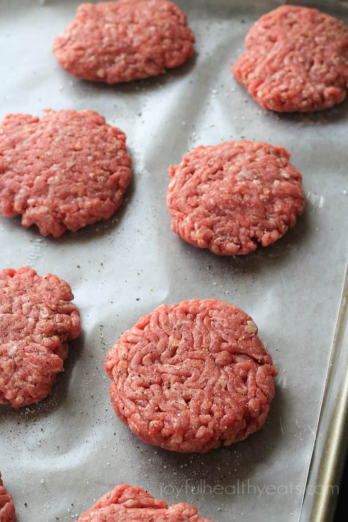 Mouthwatering Gourmet Top view of 6 raw slider burgers on parchment paper