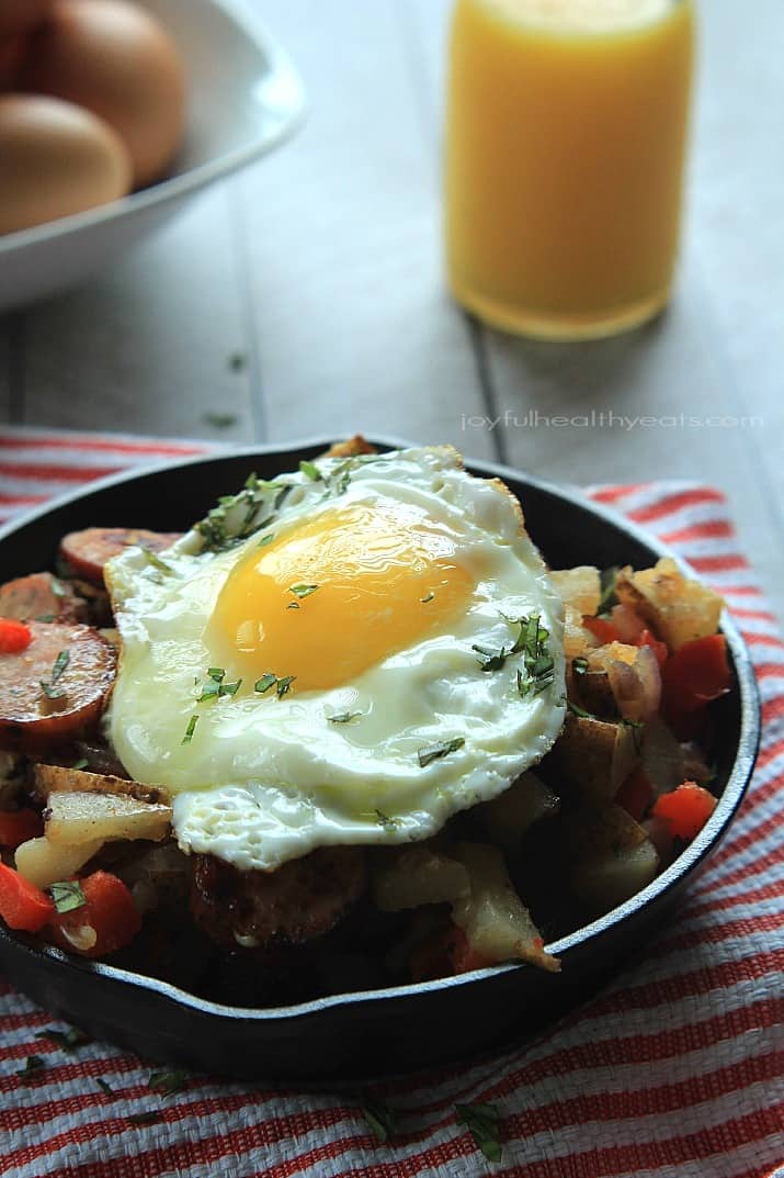 A quick easy and gluten free Chicken Sausage Potato Hash perfect for breakfast, lunch, or dinner! | m.albarakaa.com 鸡肠土豆泥放在铸铁煎锅里,上面放一个煎蛋