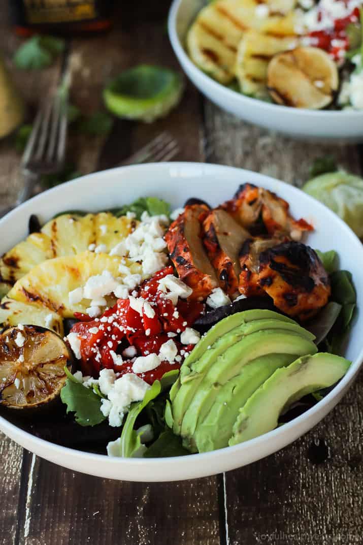 Harissa Lime Grilled Chicken Salad with a Creamy Cilantro Lime Vinaigrette, filled with grilled pineapple, limes, fresh avocado and an amazing dressing! Add to your list! | joyfulhealthyeats.com #glutenfree #recipes Harissa Lime Grilled Chicken Salad with sliced avocado, pineapple, roasted red pepper and crumbled feta