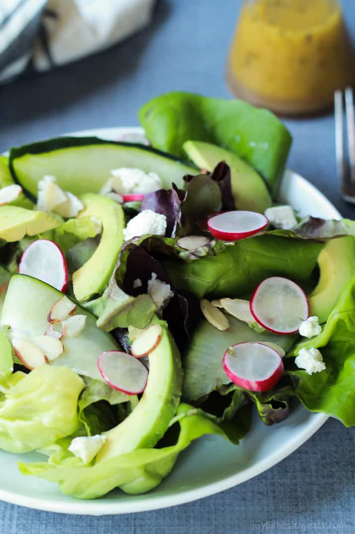A simple fresh Summer salad that takes 5 minutes - Avocado Butter Lettuce Salad filled with spicy radishes, almond slices, goat cheese, and topped with a Lemon Vinaigrette. | joyfulhealthyeats.com #recipe #glutenfree #vegetarian 牛油果黄油生菜沙拉的侧面