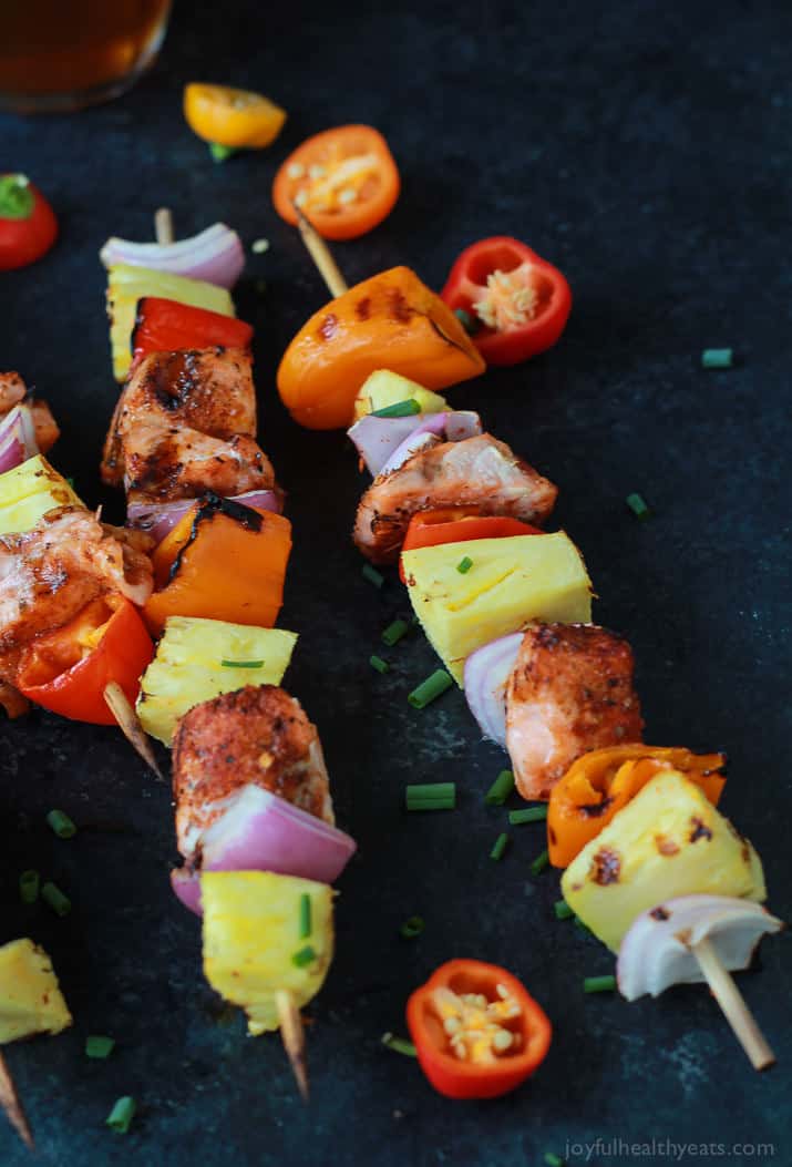 Caribbean Grilled Salmon Kabobs will take you straight to the islands with the cajun spices, fresh pineapple, bell peppers, and fresh seafood! Perfect healthy grilling recipe for the summer done in 20 minutes! | joyfulhealthyeats.com #recipes 加勒比烤三文鱼kabobs与cajun香料,新鲜的菠萝,甜椒和新鲜的海鲜