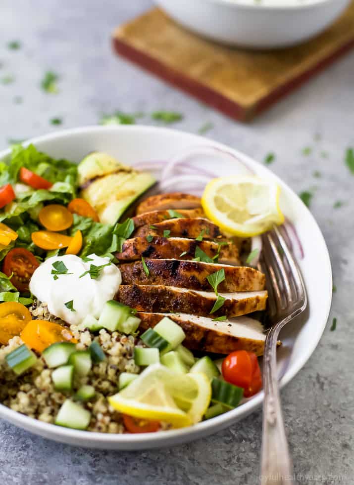 Chicken Shawarma Bowl on a bed of quinoa and lettuce and topped with diced veggies and Garlic Yogurt Sauce