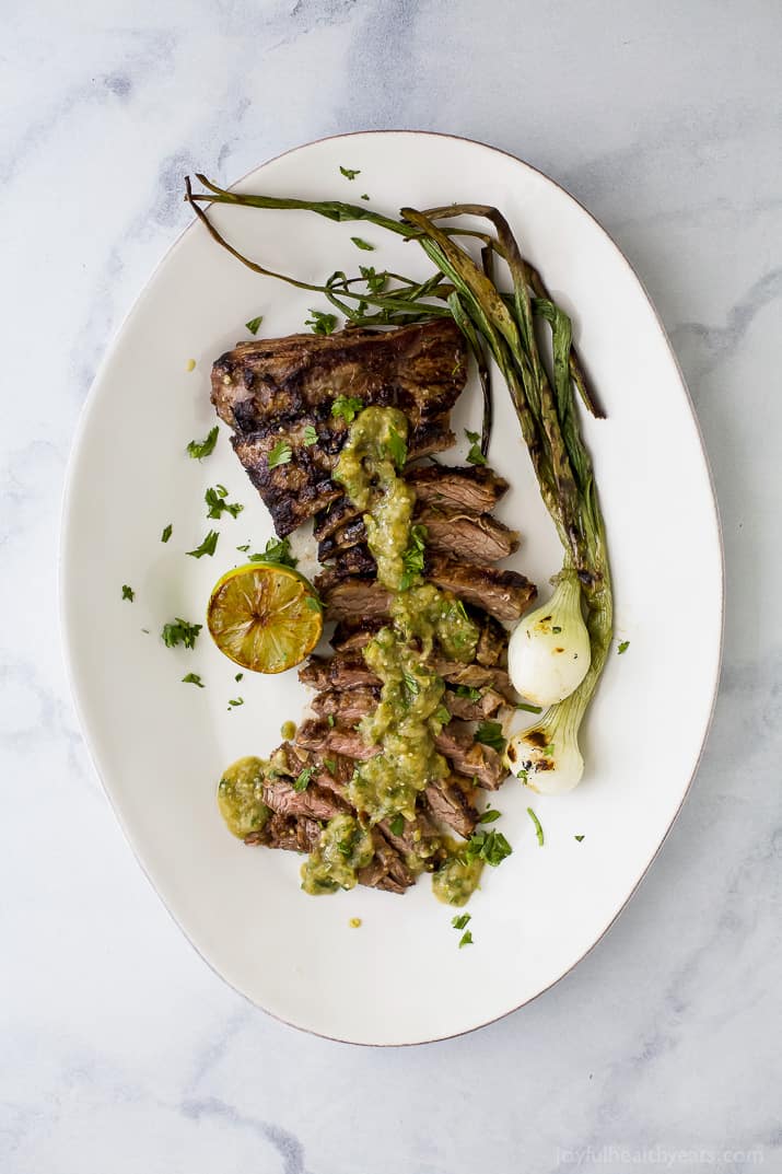 Tender grilled Carne Asada that's marinaded in a homemade Salsa Verde then charred to perfection for one authentic mexican dish! This flavorful low carb Carne Asada will be a hit at your house! Great for a weeknight dinner or dinner parties! #paleo #glutenfree