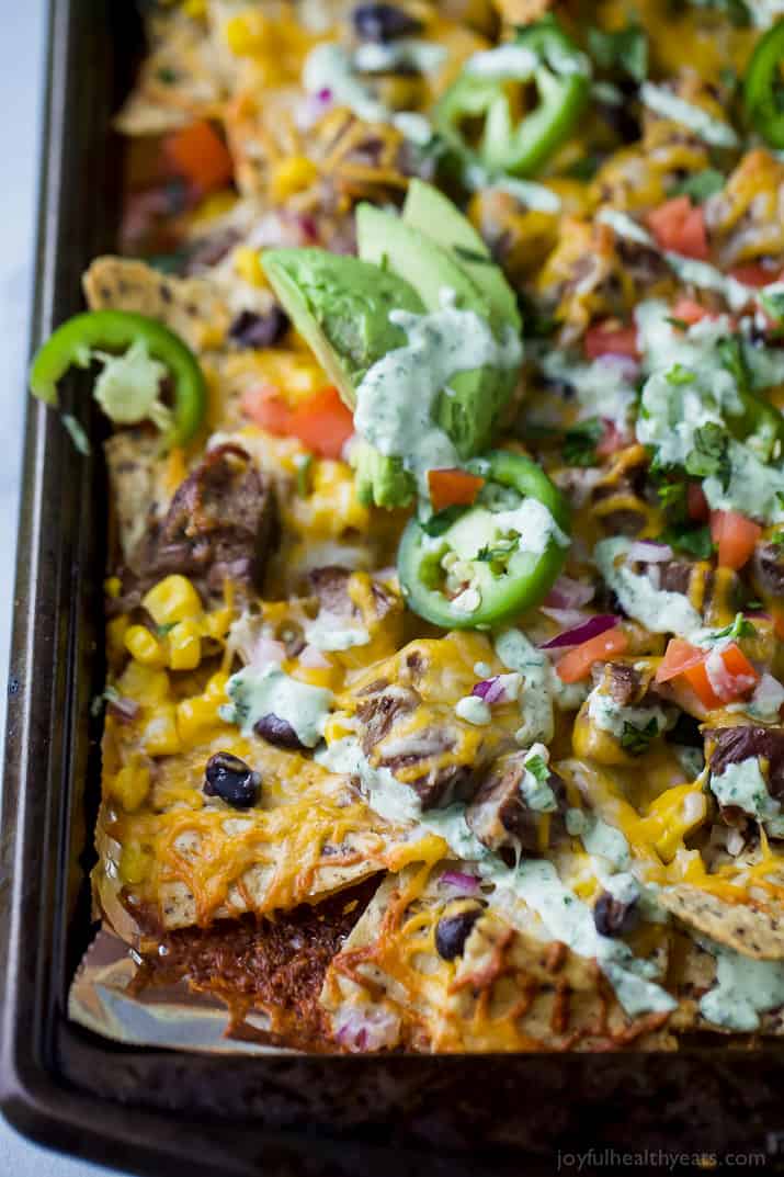 熔化奶酪覆盖的装载的牛排玉米片。