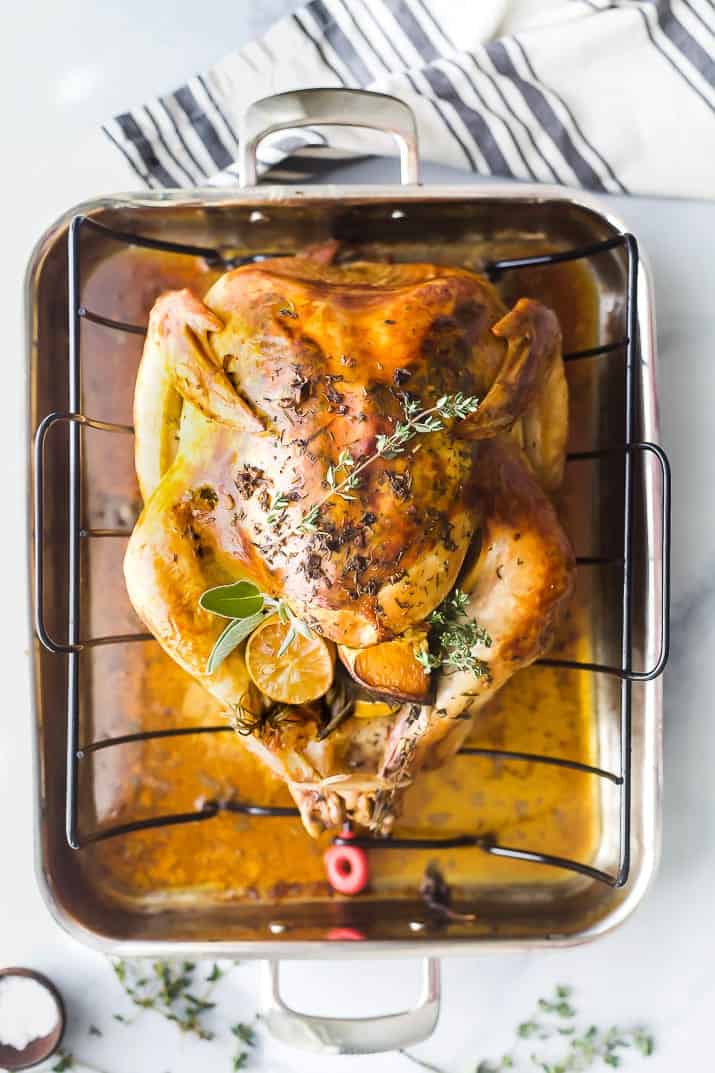 The Best Thanksgiving Turkey Recipe without Brining Finished roast turkey in a roasting pan on a marble counter