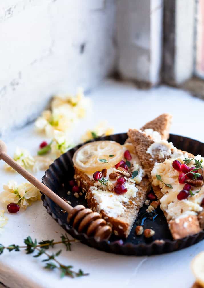 photo of pomegranate honey ricotta toast sitting on window sill