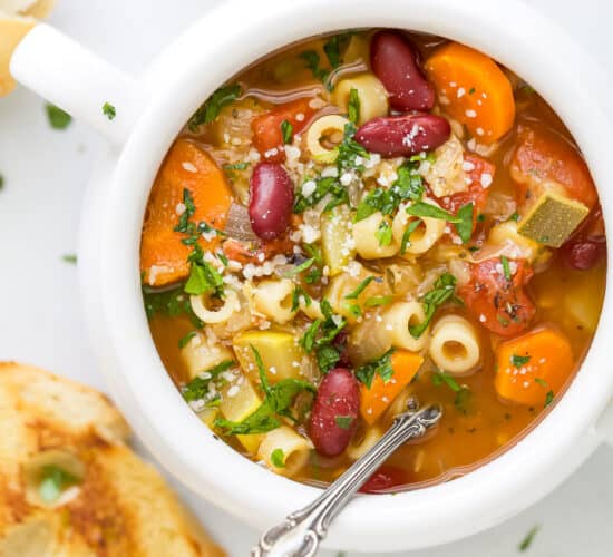 close up of minestrone soup in a soup crock