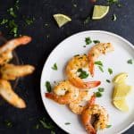 Easy 10 Minute Garlic Herb Roasted Shrimp served with a homemade Cocktail Sauce. These Roasted Shrimp are the ultimate Holiday Party Appetizer! So put that flavorless cocktail shrimp down and make these! I guarantee you'll fall in love!
