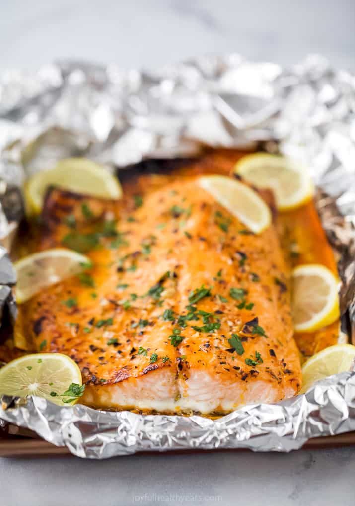 flaky baked salmon in tin foil with lemon slices