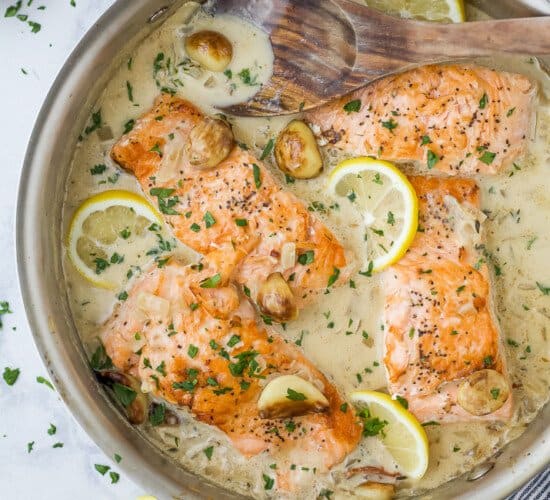 pan seared salmon with garlic cream sauce in a pan